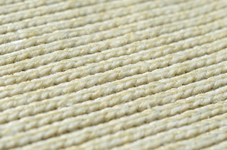 Fabric texture of a soft yellow knitted sweater. Macro image of the structure of bindings in yarnsの写真素材