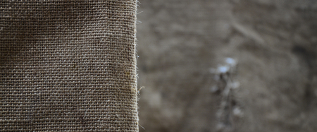 The texture of a very old brown sack cloth. Retro texture with canvas material. Background image with copy spaceの写真素材
