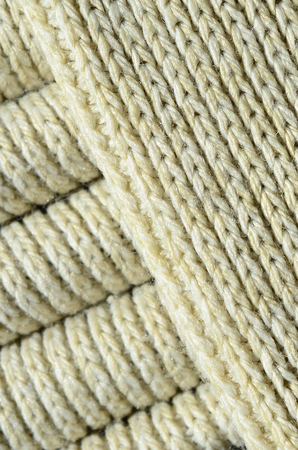 Composition of a soft yellow knitted sweater. Macro texture of bindings in yarnsの写真素材