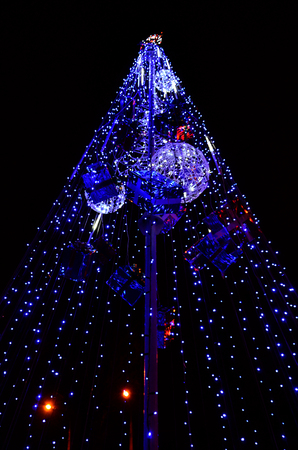Fragment of the New Year tree. A lot of round lights of blue color are located on a conical frameの写真素材