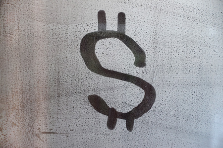 The dollar symbol on the misted sweaty glass. Abstract background image. US money conceptの写真素材