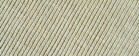 Fabric texture of a soft yellow knitted sweater. Macro image of the structure of bindings in yarnsの写真素材