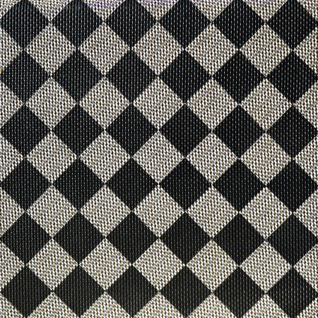 Plastic texture in the form of a very small cloth binding, painted in black and gray in the style of a chessboard. Macro shotの写真素材