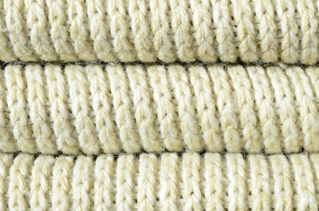 Composition of a soft yellow knitted sweater. Macro texture of bindings in yarnsの写真素材