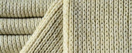 Composition of a soft yellow knitted sweater. Macro texture of bindings in yarnsの写真素材