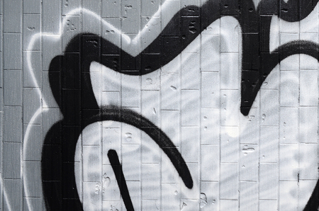 A fragment of a graffiti pattern, applied to a wall of cold tiles, which is covered with a fine condensate. The concept of street art in inappropriate weatherの写真素材