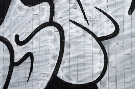 A fragment of a graffiti pattern, applied to a wall of cold tiles, which is covered with a fine condensate. The concept of street art in inappropriate weatherの写真素材