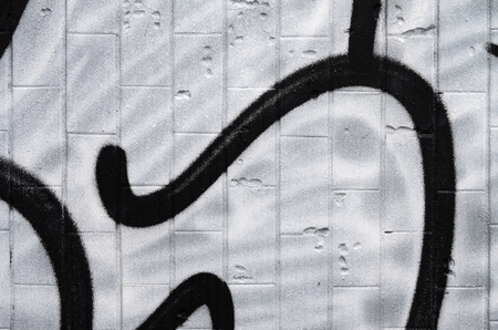 A fragment of a graffiti pattern, applied to a wall of cold tiles, which is covered with a fine condensate. The concept of street art in inappropriate weatherの写真素材