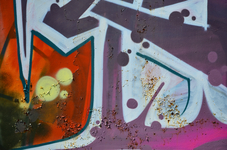 The old wall, painted in color graffiti drawing red aerosol paints. Background image on the theme of drawing graffiti and street artの写真素材