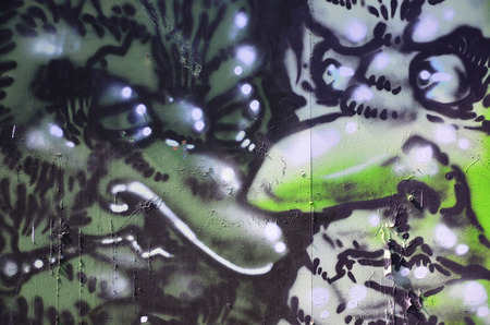 The old wall, painted in color graffiti drawing with aerosol paints. The image of terrible faces. Background image for Halloweenの写真素材