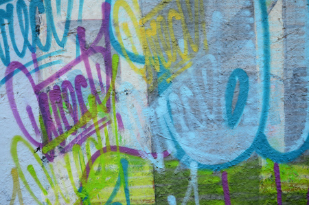Texture of a fragment of the wall with graffiti painting, which is depicted on it. An image of a piece of graffiti drawing as a photo on street art and graffiti culture topicsの写真素材