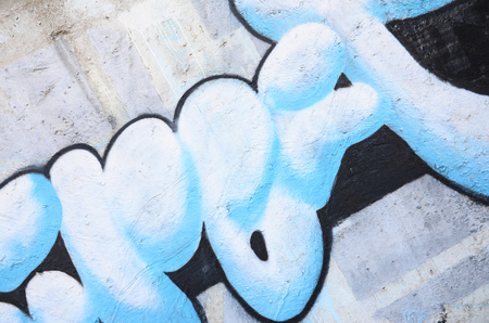 Texture of a fragment of the wall with graffiti painting, which is depicted on it. An image of a piece of graffiti drawing as a photo on street art and graffiti culture topicsの写真素材