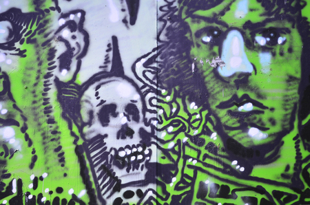The old wall, painted in color graffiti drawing with aerosol paints. The image of terrible faces. Background image for Halloweenの写真素材