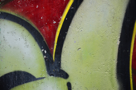Texture of a fragment of the wall with graffiti painting, which is depicted on it. An image of a piece of graffiti drawing as a photo on street art and graffiti culture topicsの写真素材