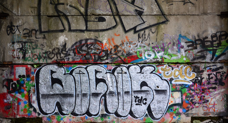 Texture of a fragment of the wall with graffiti painting, which is depicted on it. An image of a piece of graffiti drawing as a photo on street art and graffiti culture topicsの写真素材