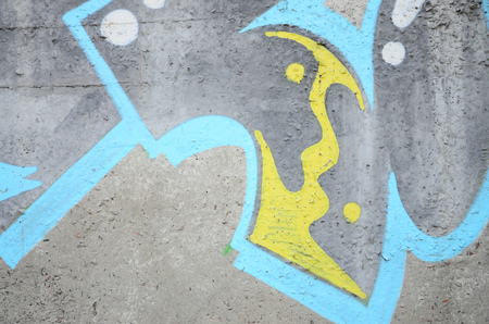 Texture of a fragment of the wall with graffiti painting, which is depicted on it. An image of a piece of graffiti drawing as a photo on street art and graffiti culture topicsの写真素材