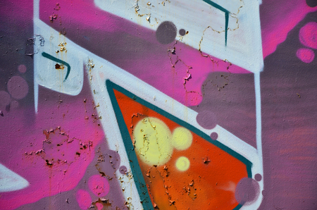 The old wall, painted in color graffiti drawing red aerosol paints. Background image on the theme of drawing graffiti and street artの写真素材