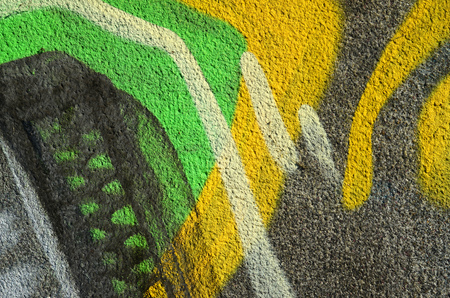 Concrete weathered worn wall damaged paint. Grungy Concrete Surface with graffiti colors and outlines. Street art background texture. Close up painted wall of the cityの写真素材