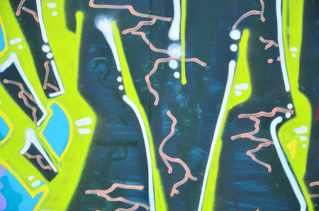 The old wall, painted in color graffiti drawing green aerosol paints. Background image on the theme of drawing graffiti and street artの写真素材