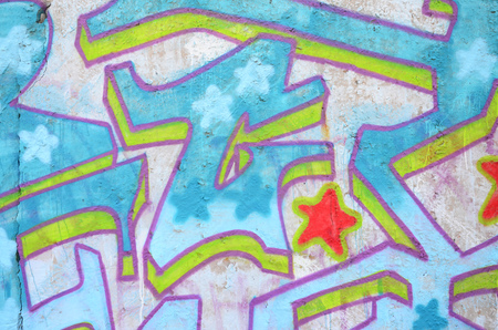 Texture of a fragment of the wall with graffiti painting, which is depicted on it. An image of a piece of graffiti drawing as a photo on street art and graffiti culture topicsの写真素材