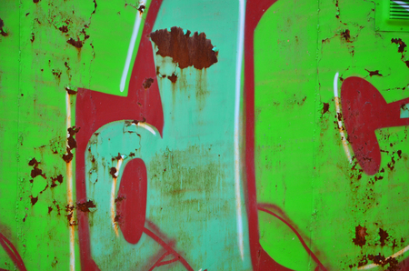 The old wall, painted in color graffiti drawing green aerosol paints. Background image on the theme of drawing graffiti and street artの写真素材