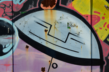The old wall, painted in color graffiti drawing with aerosol paints. Background image on the theme of drawing graffiti and street artの写真素材