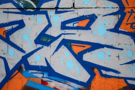 A fragment of graffiti drawing using contours, applied to the wall with the help of cans with aerosol paints over the colored filling areas. Background texture of street art and vandalismの写真素材