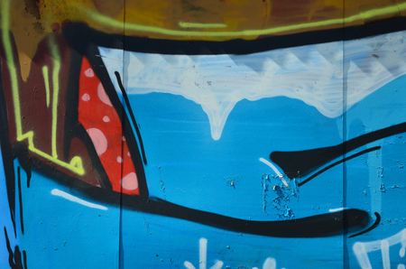 The old wall, painted in color graffiti drawing blue aerosol paints. Background image on the theme of drawing graffiti and street artの写真素材