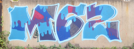 Background image with a graffiti pattern, which is applied to a concrete wall with aerosol paintsの写真素材
