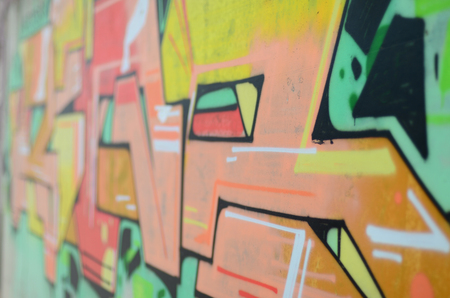 Background image with a colored graffiti pattern, which is applied to the concrete wall with aerosol...
