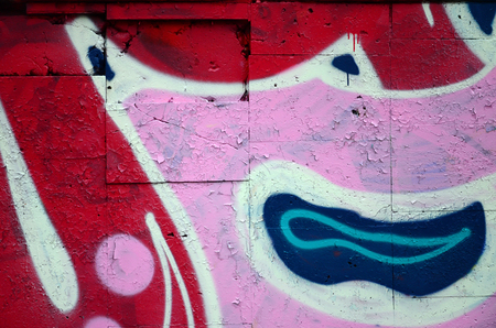 A fragment of graffiti drawing using contours, applied to the wall with the help of cans with aerosol paints over the colored filling areas. Background texture of street art and vandalismの写真素材