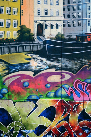 A fragment of detailed graffiti of a drawing made with aerosol paints on a wall of concrete tiles. Background image of street art with the architecture of Veniceの写真素材