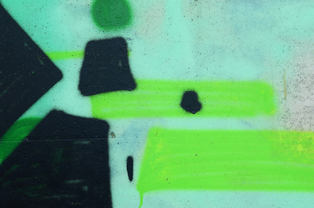 Background image with a colored graffiti pattern, which is applied to the concrete wall with aerosol paints. A lot of contours and fragments filled with paint, forming an interesting compositionの写真素材