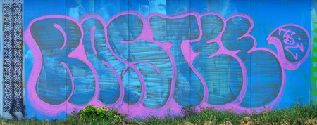 The old wall, painted in color graffiti drawing blue aerosol paints. Background image on the theme of drawing graffiti and street artの写真素材
