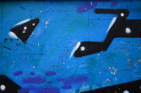A fragment of graffiti drawing using contours, applied to the wall with the help of cans with aerosol paints over the colored filling areas. Background texture of street art and vandalismの写真素材