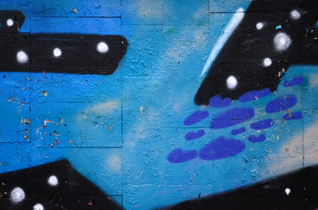 A fragment of graffiti drawing using contours, applied to the wall with the help of cans with aerosol paints over the colored filling areas. Background texture of street art and vandalismの写真素材