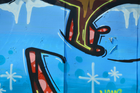 The old wall, painted in color graffiti drawing blue aerosol paints. Background image on the theme of drawing graffiti and street artの写真素材