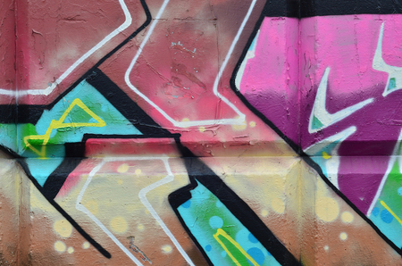 Multicolored graffiti on an old concrete wall. A beautiful form of vandalism in urban conditions. Different lines and shapes, painted with cans of paint for graffiti. Youth contemporary artの写真素材