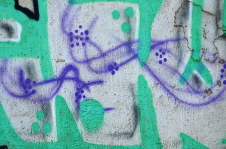 Close up view of graffiti drawing details. Background image on the theme of street art and vandalism. Texture of the wall, painted with aerosol paintsの写真素材