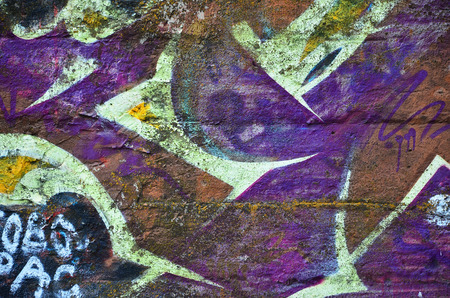 Close up view of graffiti drawing details. Background image on the theme of street art and vandalism. Texture of the wall, painted with aerosol paintsの写真素材