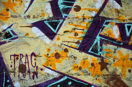 Close up view of graffiti drawing details. Background image on the theme of street art and vandalism. Texture of the wall, painted with aerosol paintsの写真素材