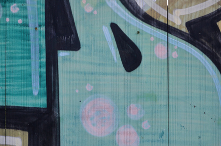 Close up view of graffiti drawing details. Background image on the theme of street art and vandalism. Texture of the wall, painted with aerosol paintsの写真素材