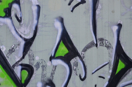 Close up view of graffiti drawing details. Background image on the theme of street art and vandalism. Texture of the wall, painted with aerosol paintsの写真素材