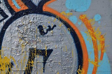 Fragment of an old colored graffiti drawing on the wall. Background image as an illustration of street art, vandalism and wall painting with aerosol paintの写真素材