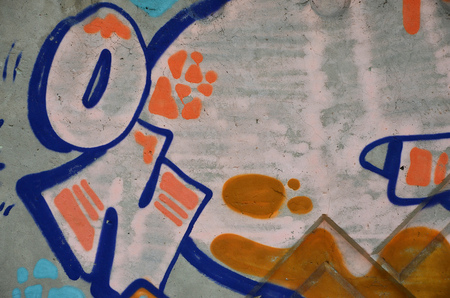 Texture of a fragment of the wall with graffiti painting, which is depicted on it. An image of a piece of graffiti drawing as a photo on street art and graffiti culture topicsの写真素材