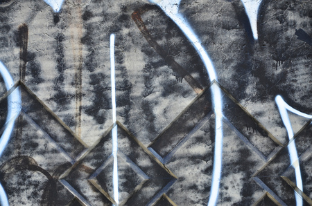 Texture of a fragment of the wall with graffiti painting, which is depicted on it. An image of a piece of graffiti drawing as a photo on street art and graffiti culture topicsの写真素材