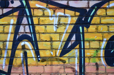 Texture of a fragment of the wall with graffiti painting, which is depicted on it. An image of a piece of graffiti drawing as a photo on street art and graffiti culture topicsの写真素材