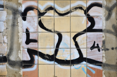 Texture of a fragment of the wall with graffiti painting, which is depicted on it. An image of a piece of graffiti drawing as a photo on street art and graffiti culture topicsの写真素材