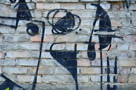 Texture of a fragment of the wall with graffiti painting, which is depicted on it. An image of a piece of graffiti drawing as a photo on street art and graffiti culture topicsの写真素材
