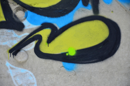 Texture of a fragment of the wall with graffiti painting, which is depicted on it. An image of a piece of graffiti drawing as a photo on street art and graffiti culture topicsの写真素材
